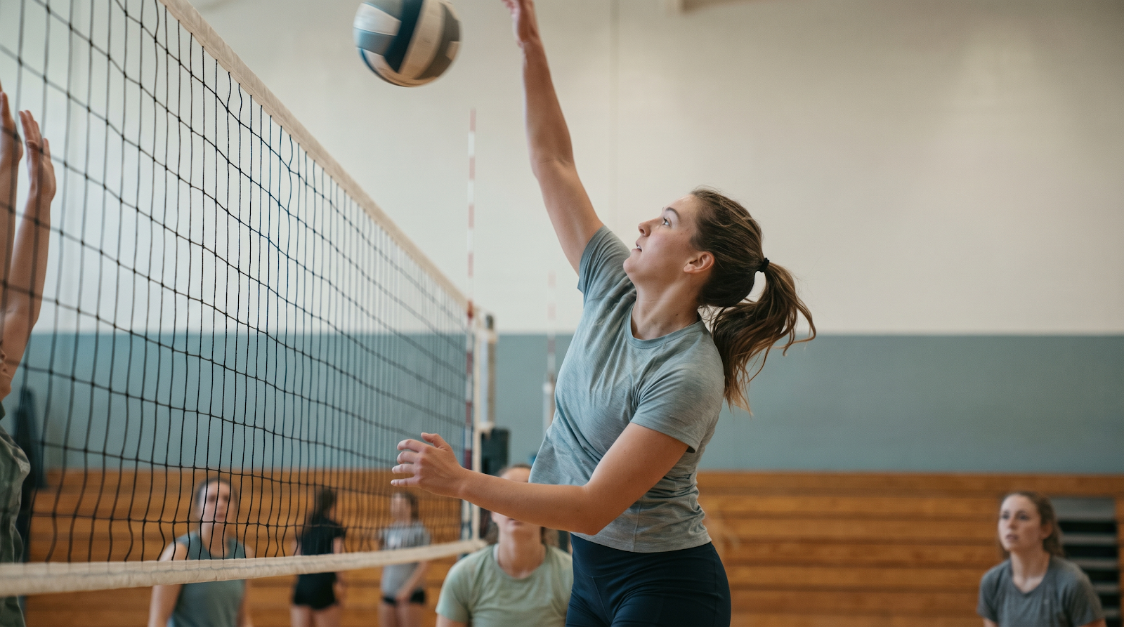 Volleyball player spiking indoors